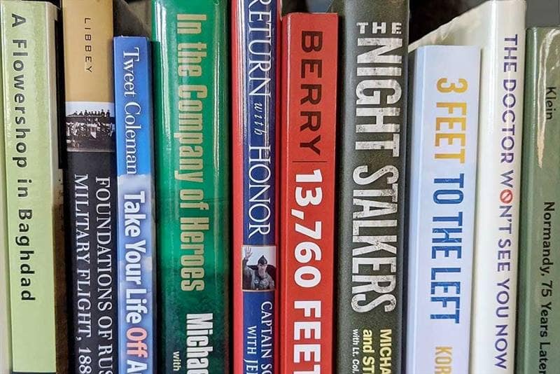 Display of stacked books written by Embry-Riddle authors